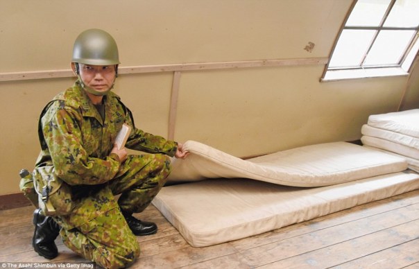34df866f00000578-3622997-a_soldier_shows_the_mattresses_that_yamato_had_been_sleeping_bet-a-8_1464935261677